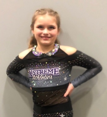 Photo of a smiling girl in a dance uniform after completing the Eat to Lose program
