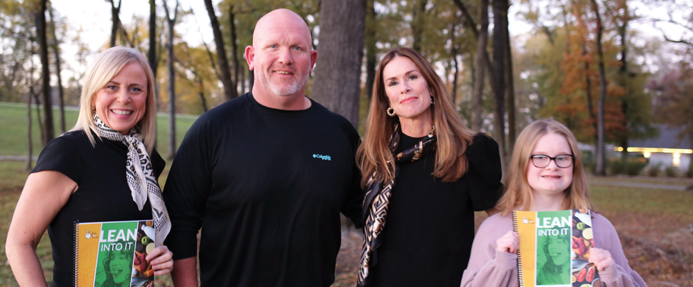 Photo of Andi with three happy clients.